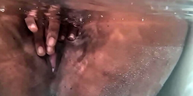 Tattooed Indian slut plays with her boobs and dark cunt beneath the water while in the bathtub