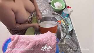 Indian Desi Bhabhi was working in the kitchen washing dishes and showing her Big Boobs