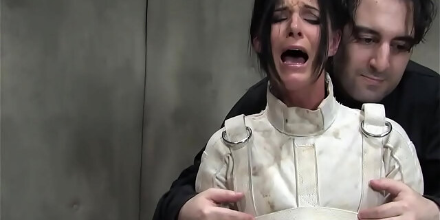 Tanned dark-haired tied in straitjacket