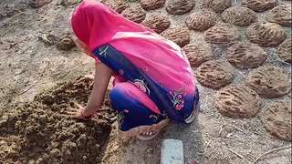 The village Bhabhi went to the brim of the village to throw cow dung and started getting her poon fucked