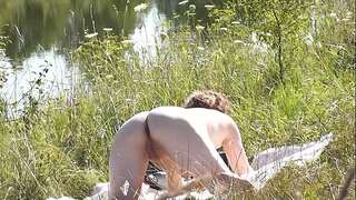 A casual passerby youthful man spotted a naked Milf sunbathing on river bank. Peeping. Spy camera. Naked in public. Nude beach. Wild beach