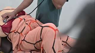 Indian doctor checking woman patient in clinic