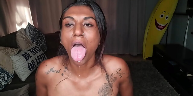 Desi sits on the couch drooling as she sticks out and wiggles her tongue around